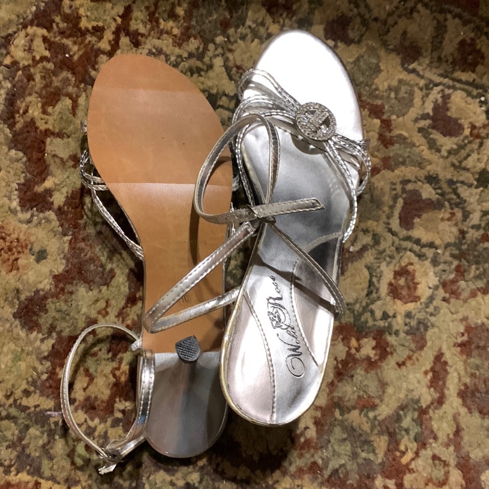 Silver dress shoes with clear stones at toe’s